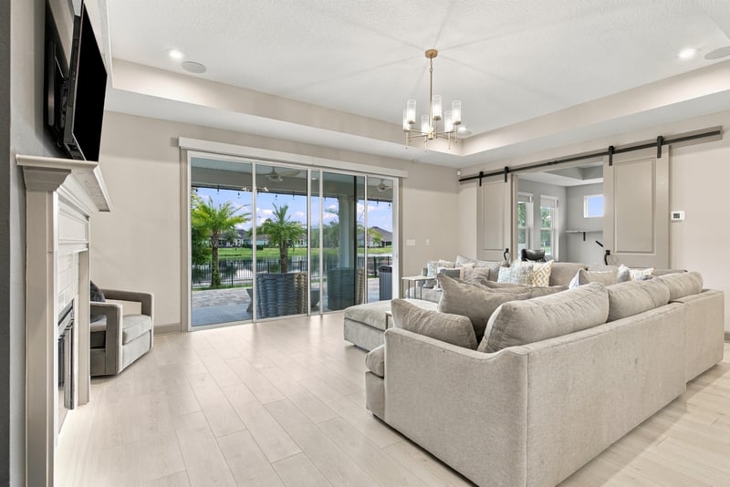 Living room with sliding glass doors to the lanai at 3921 Spyglass Hill Ln