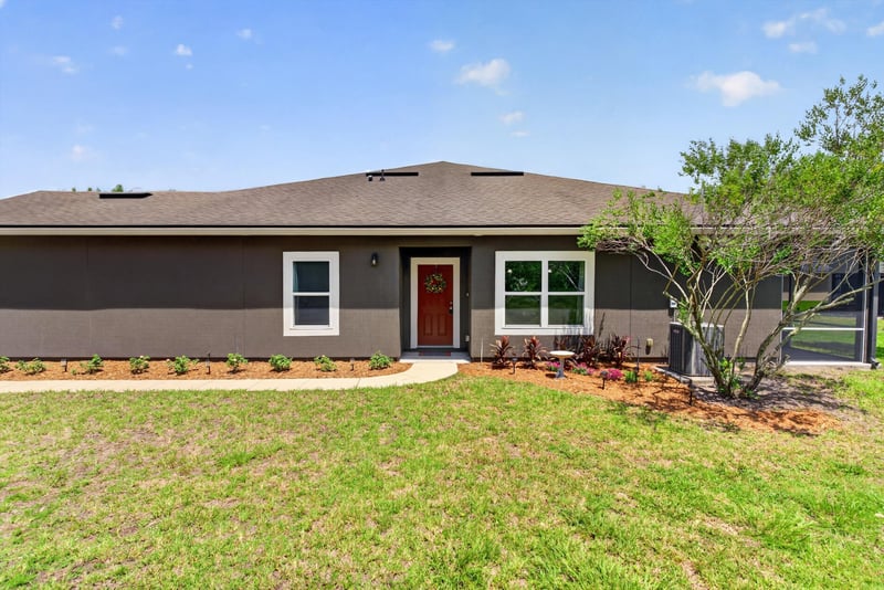 Front entry with red door and covered stoop at 2378 Caney Oaks Dr, Jacksonville, FL