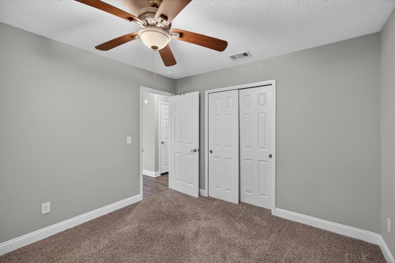 Carpeted bedroom with double closets at 12344 Cormorant Ct, Jacksonville, FL
