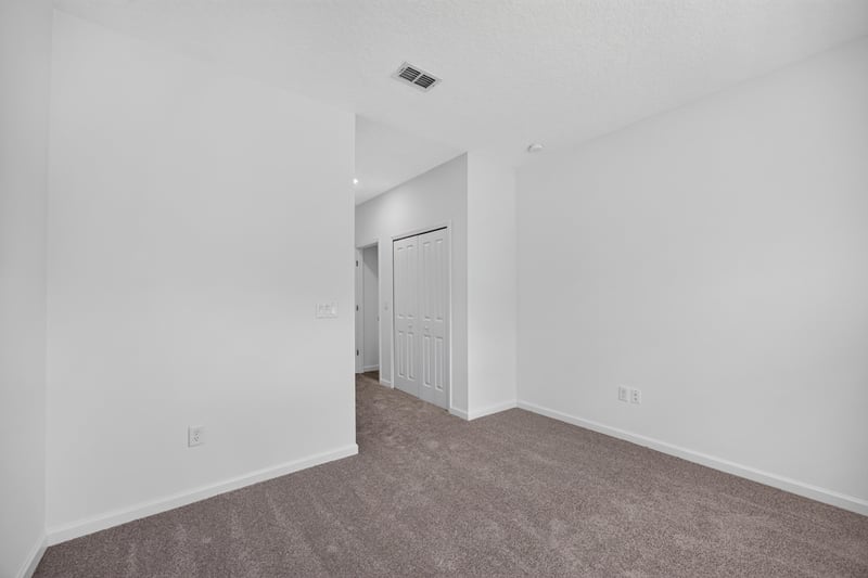 Bedroom corner with hallway doorway at 9905 Ansley Lake Dr, Jacksonville, FL