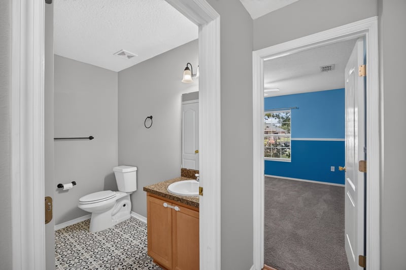Bathroom doorway with tile floor and bedroom beyond at 7545 Lirope St, Jacksonville, FL 32244