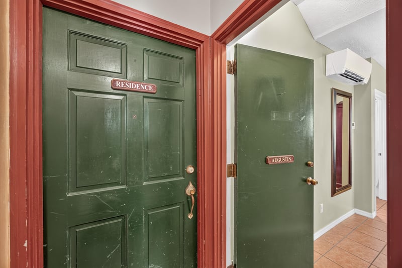 Green entry doors marked Residence at 115 Cordova St, St. Augustine, FL