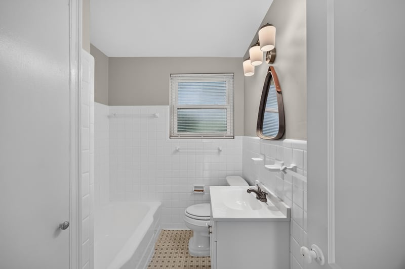 Bathroom with tub, pedestal sink and tile at 6338 Mercer Cir W, Jacksonville, FL