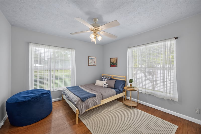 Bedroom with blue ottoman and large window at 5843 Ovella Rd, Jacksonville, FL 32244
