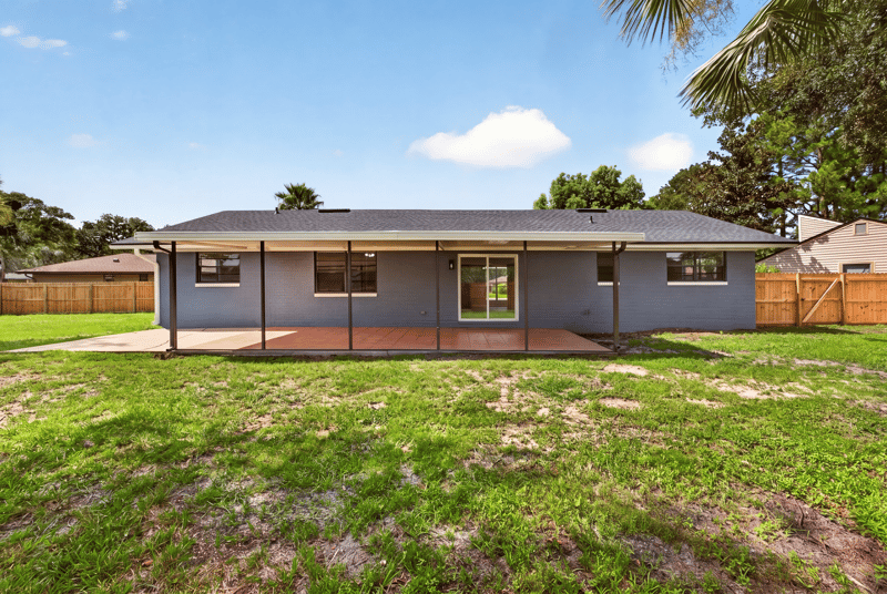Rear exterior with covered patio and open yard at 4117 Wilcrest Ct, Jacksonville, FL 32277