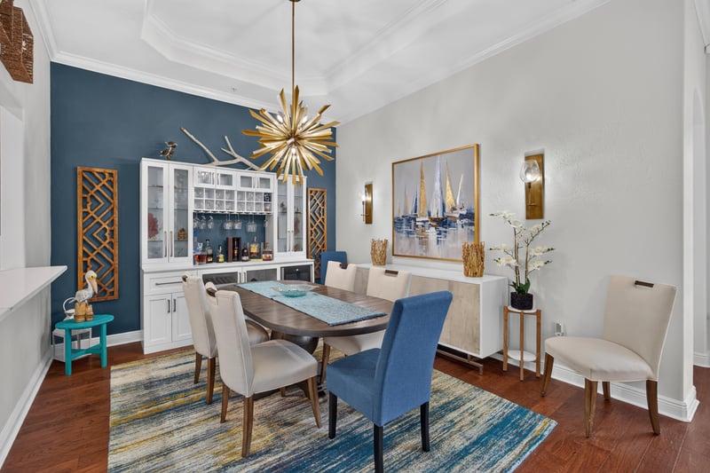 Dining room with chandelier and blue dining chairs at 140 Ave De La Mer, Palm Coast, FL 32137