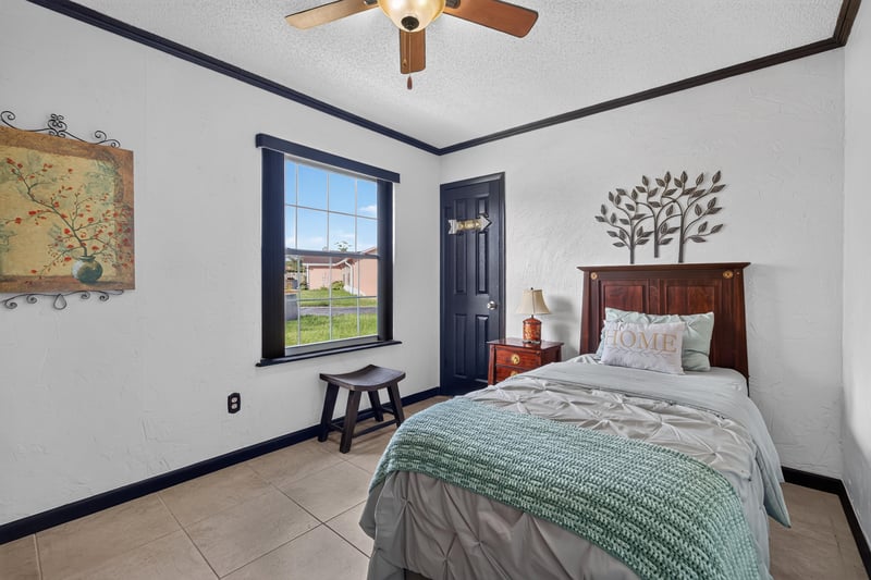 Bedroom with twin bed and map art at 6931 Cane Grass Ln E, Jacksonville, FL 32244