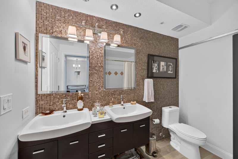 Bathroom with double vanity and framed mirror at 10435 Mid Town Pkwy unit 135, Jacksonville, FL 32246