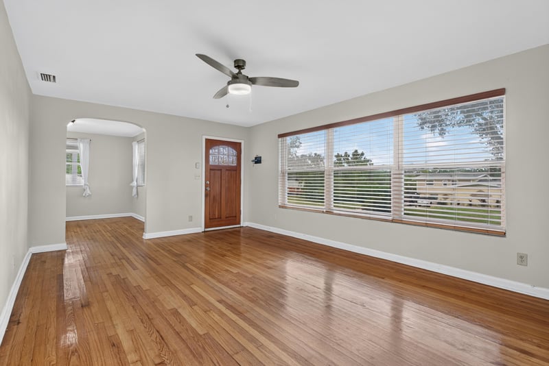 Living room with wood floors, front door and large window at 217 Baisden Rd, Jacksonville, FL 32218