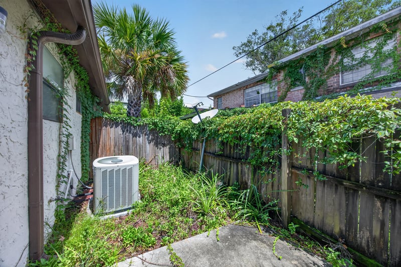 Backyard with concrete patio and AC unit at 2717 Trollie Ln, Jacksonville, FL
