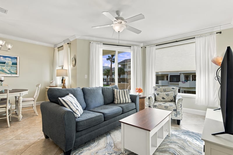 Living room with sofa and dining table beyond at 805 Spinnakers Reach Dr, Ponte Vedra Beach, FL 32082