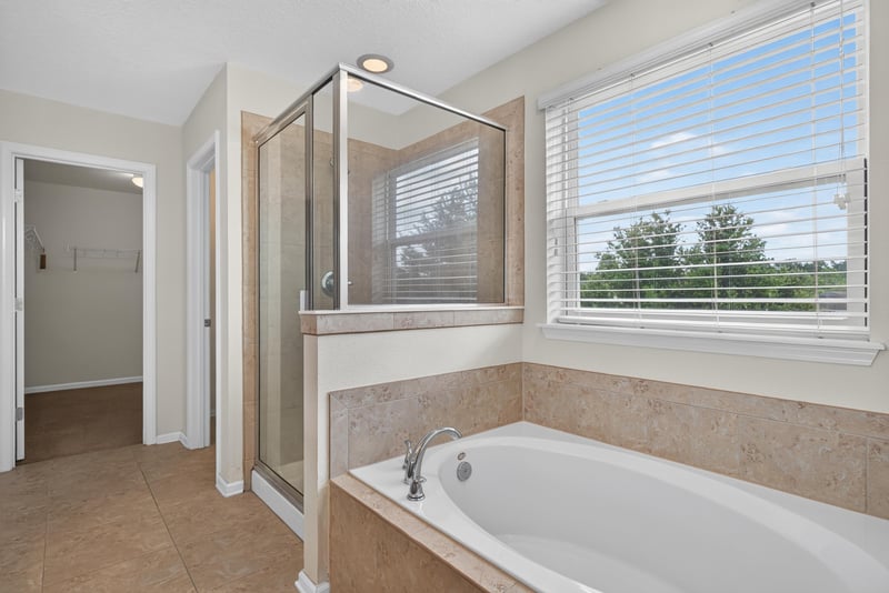 Primary bathroom with walk-in shower and soaking tub at 263 Gilmore Ln, Orange Park, FL 32065