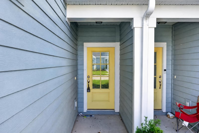 Side entry door with teal siding and yellow door at 39 Mellowood Ln, St. Augustine, FL 32092