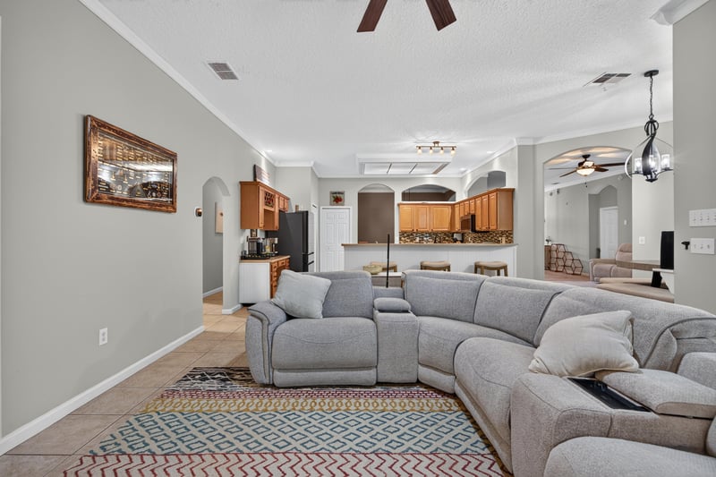 Living room sectional with patterned rug at 2125 Blue Heron Cove Dr, Orange Park, FL 32003
