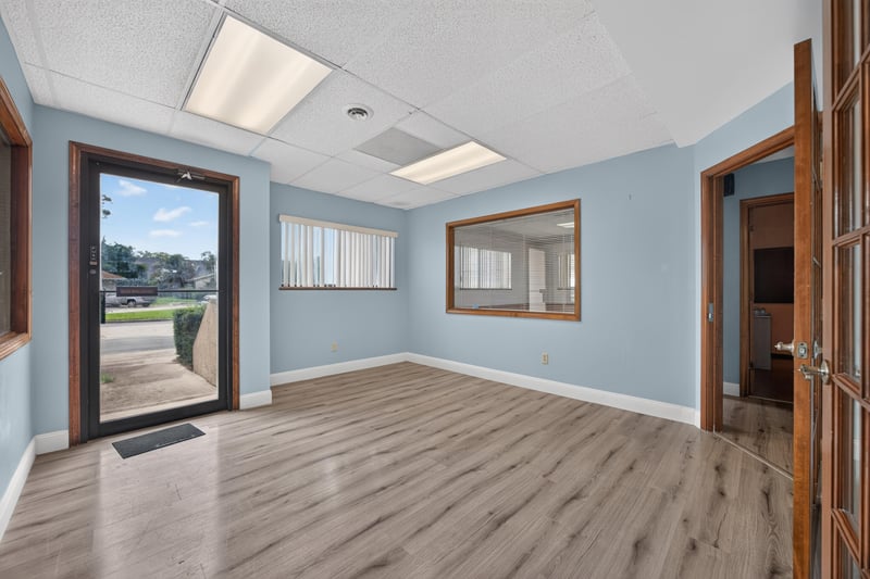Room with exterior door and wood-look floor at 1543 Kingsley Ave #19, Orange Park, FL 32073