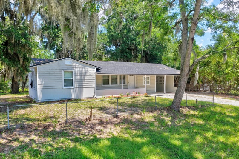 Front exterior view of ranch home with mature trees at 855 Cornwallis Dr, Jacksonville, FL