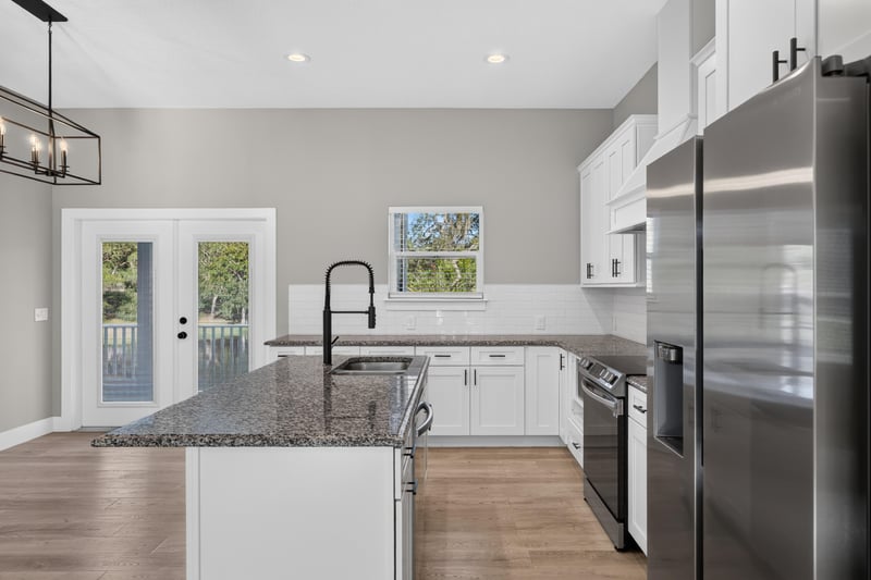 Kitchen sink area with french doors and island at 175 Alava Ct