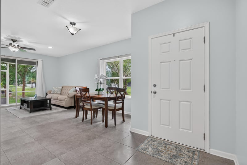 Living room with front door and dining table beyond at 2378 Caney Oaks Dr, Jacksonville, FL