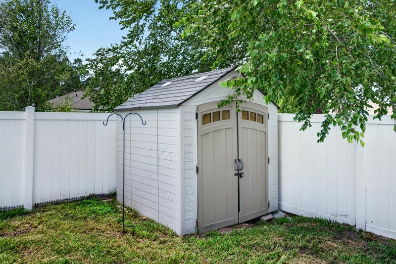 Backyard storage shed along the fence line at 10066 Andean Fox Dr, Jacksonville, FL 32222