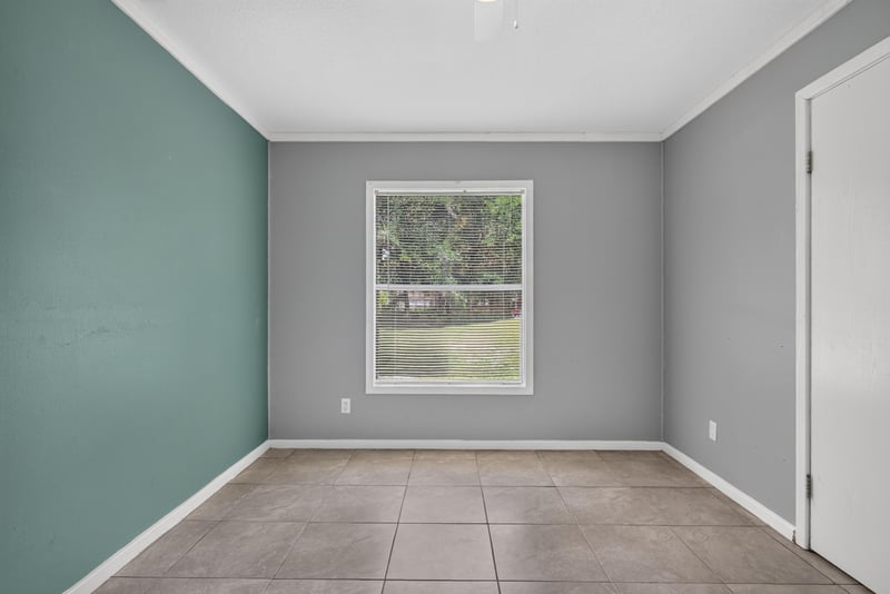 Bedroom with window view of trees at 2549 Snapdragon Ave, Middleburg, FL 32068