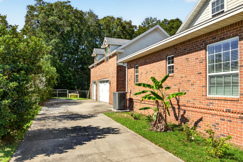 Side exterior with driveway and brick facade at 1735 Hagans Ridge Ct