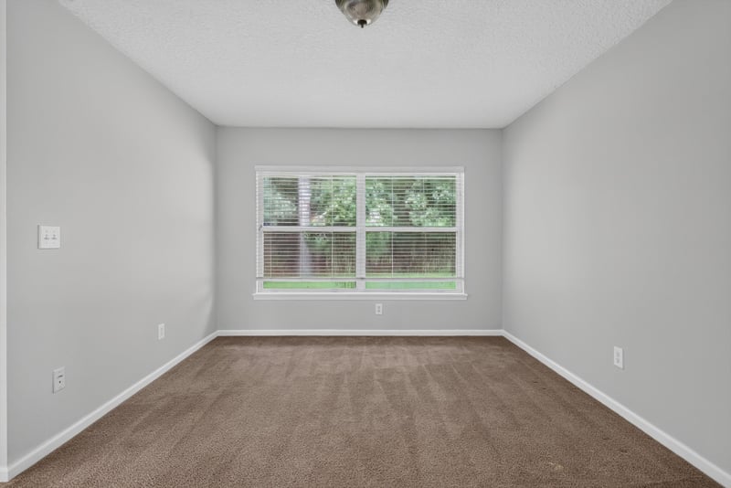 Empty carpeted room with window at 11669 Collins Creek Dr, Jacksonville, FL 32258