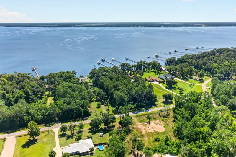 Aerial view of a dock extending into the river at 110 River Shores Rd, Palatka, FL 32043