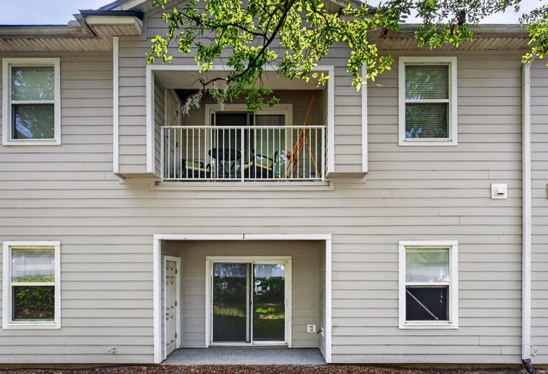 Rear exterior view with second-floor balcony at 8196 Cabin Lake Cir, Jacksonville, FL 32256