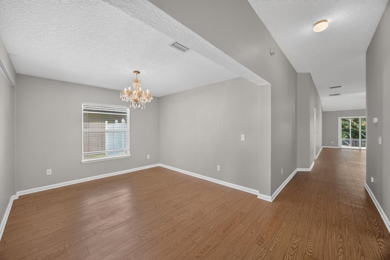 Dining area with chandelier and hallway view at 14147 Fish Eagle Dr E, Jacksonville, FL 32226