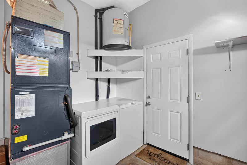 Utility closet with water heater and washer-dryer hookups at 1847 Grove Park Dr, Orange Park, FL