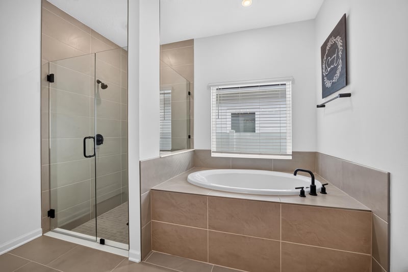 Bathroom with glass shower and soaking tub at 2354 Jennings Farm Dr, Middleburg, FL 32068