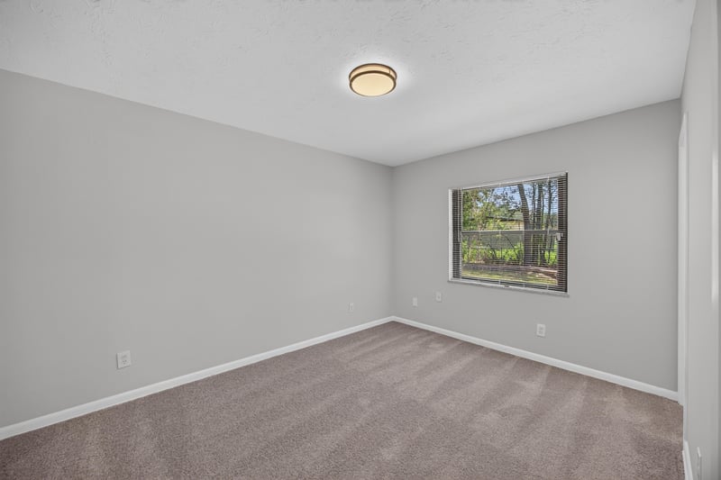 Empty bedroom with carpet and window at 7453 Jade Dr N, Jacksonville, FL 32210