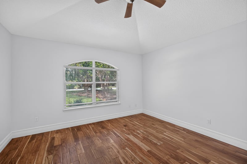 Secondary bedroom with window and wood floors at 11675 Magnolia Estates Rd, Jacksonville, FL 32223