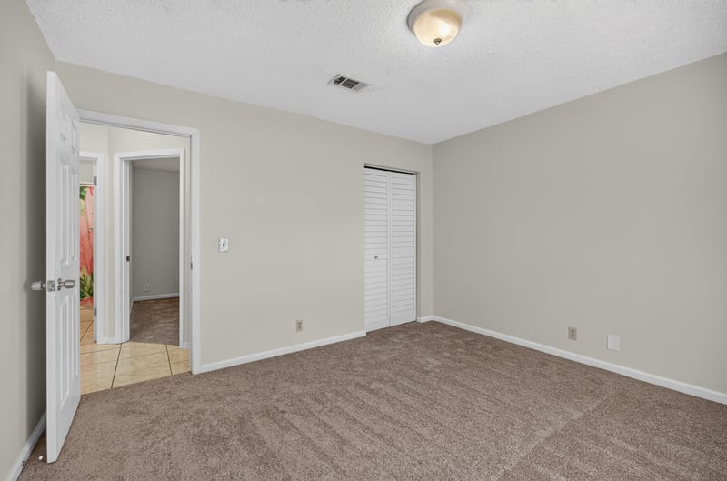 Bedroom with carpet, closet and hallway door at 2829 Blackberry Ave