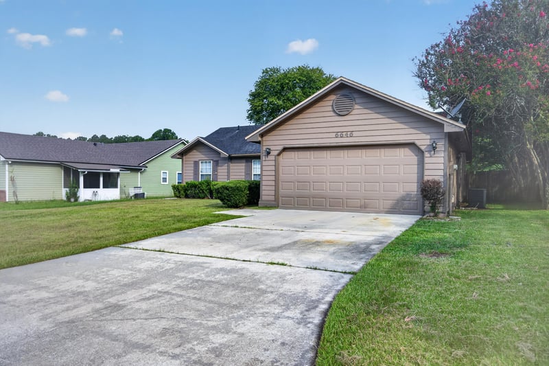 Front exterior showing garage door and driveway at 6646 Shiloh Creek Dr