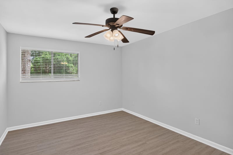 Bedroom with ceiling fan and window at 3801 Crown Point Rd unit 2061, Jacksonville, FL 32257
