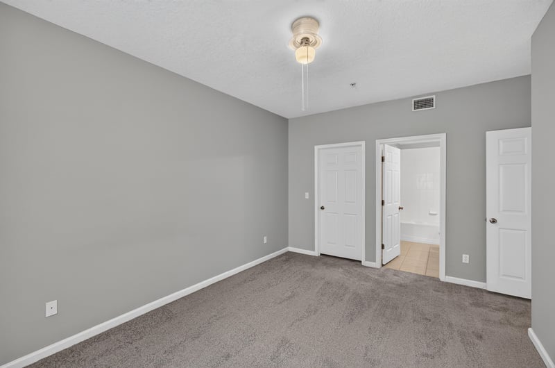 Bedroom with two doors and carpet at 575 Oakleaf Plantation Pkwy, Orange Park, FL 32065
