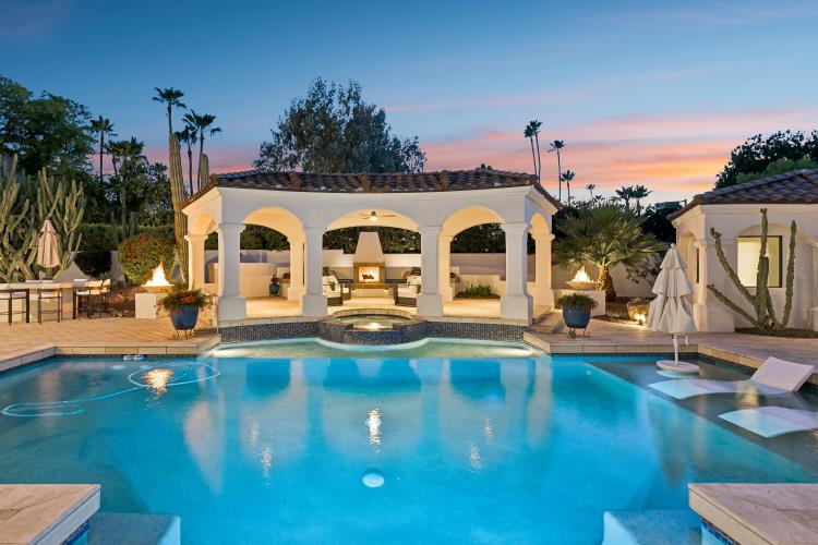 Paradise Valley residence at twilight with lit loggia and pool