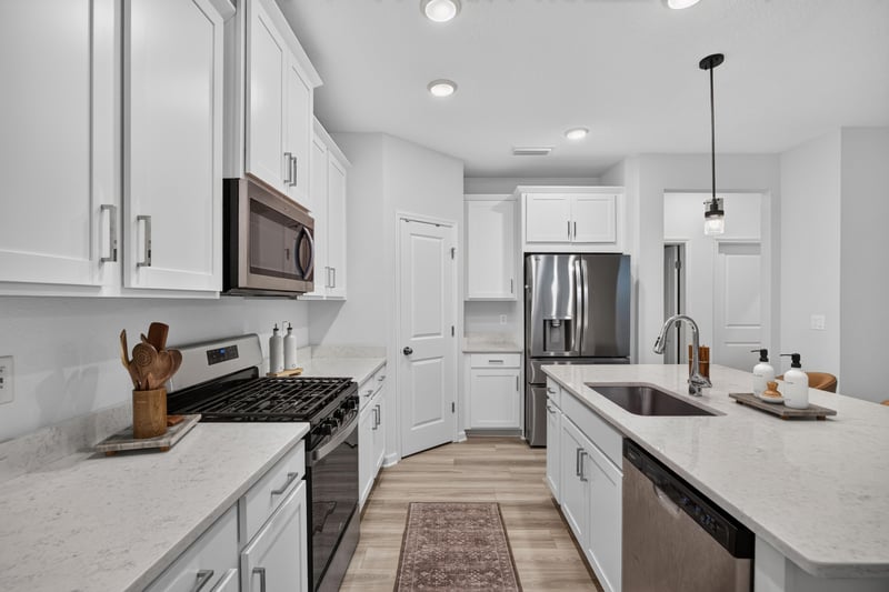 Kitchen range and white cabinets at 93 Lochloosa Ct, St. Johns, FL 32259