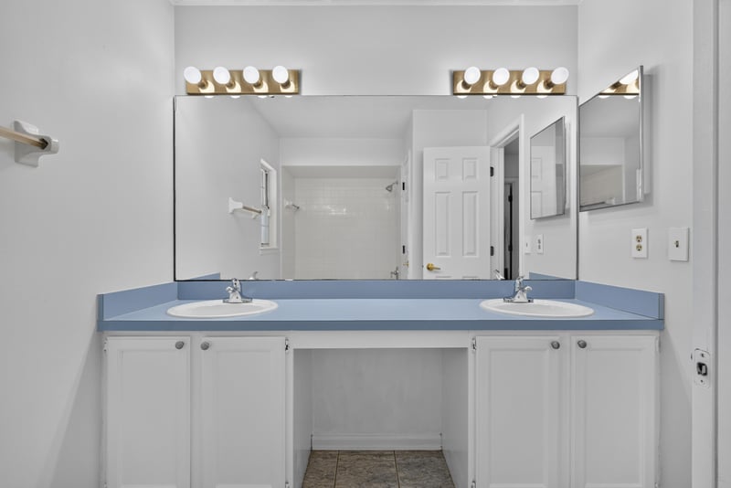 Bathroom vanity with mirrors at 12810 Swamp Owl Ln