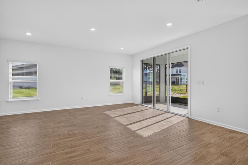 Living space with windows and open kitchen beyond at 269 Bluegrass Wy, St. Augustine, FL 32092