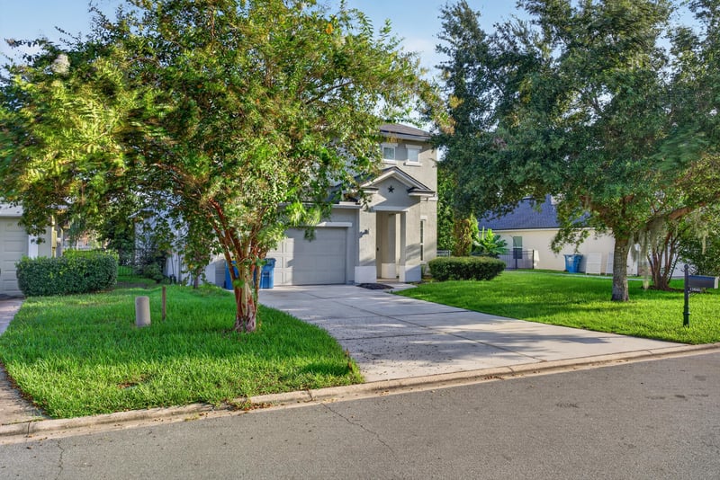 Street view of front exterior with trees and driveway at 13685 Goodson Pl, Jacksonville, FL 32226