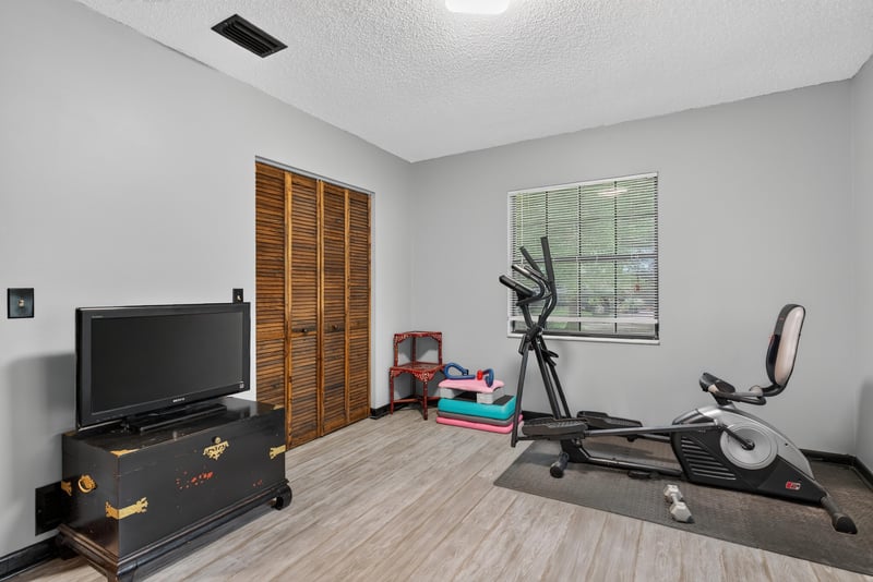 Bedroom with wood wardrobe and closet doors at 3249 Maryland Ave, Green Cove Springs, FL