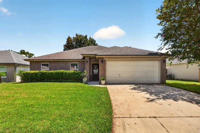 Front exterior with two-car garage at 1589 Backwater Drive, Middleburg, FL 32068