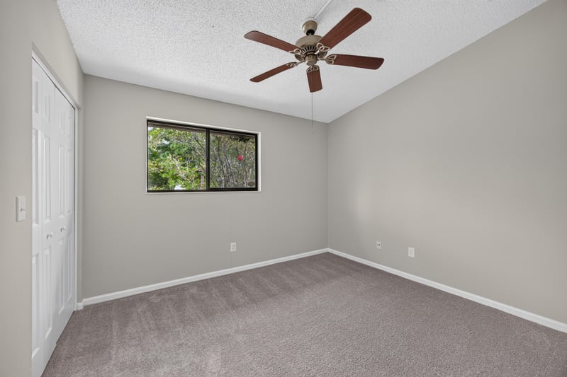 Virtually staged bedroom with bed and nightstands at 3801 Crown Point Rd, Jacksonville, FL 32257