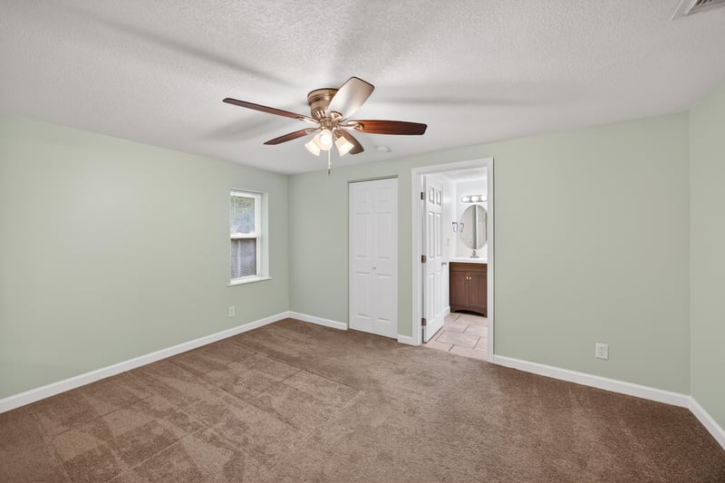 Empty room with light flooring and two doorways at 1619 Hammond Blvd, Jacksonville, FL