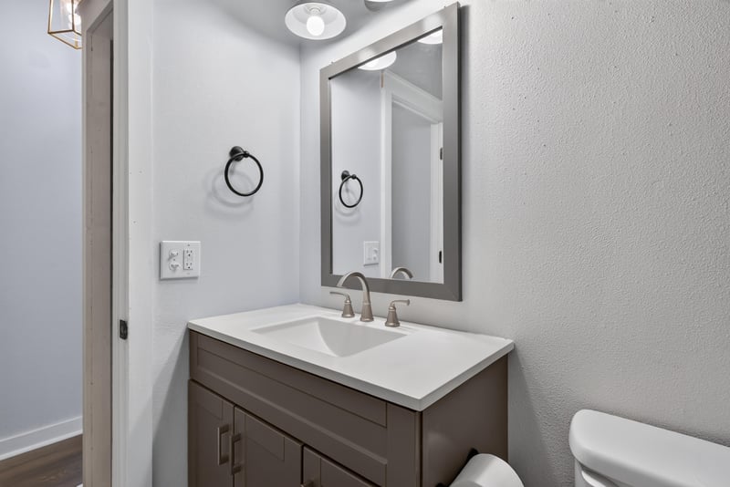 Bathroom sink and mirror with dark wood vanity at 4890 McAllister Rd, Middleburg, FL 32068