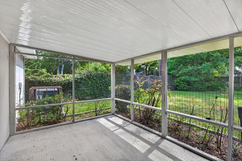 Screened porch overlooking backyard trees at 1002 Ingleside Ave, Jacksonville, FL 32205