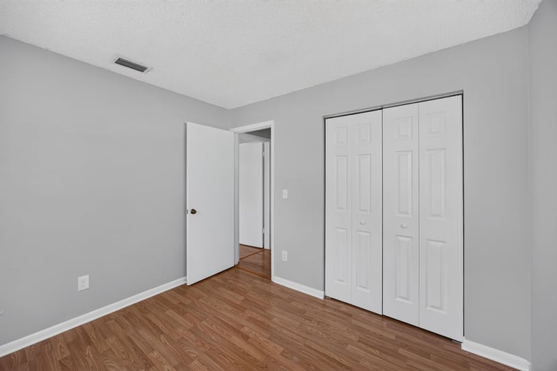 Bedroom with double closet doors and wood laminate floor at 328 Palos Ct, St. Augustine, FL