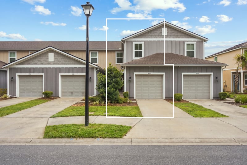 Front elevation with this unit outlined among neighboring townhomes at 9555 Star Dr, Jacksonville, FL 32256